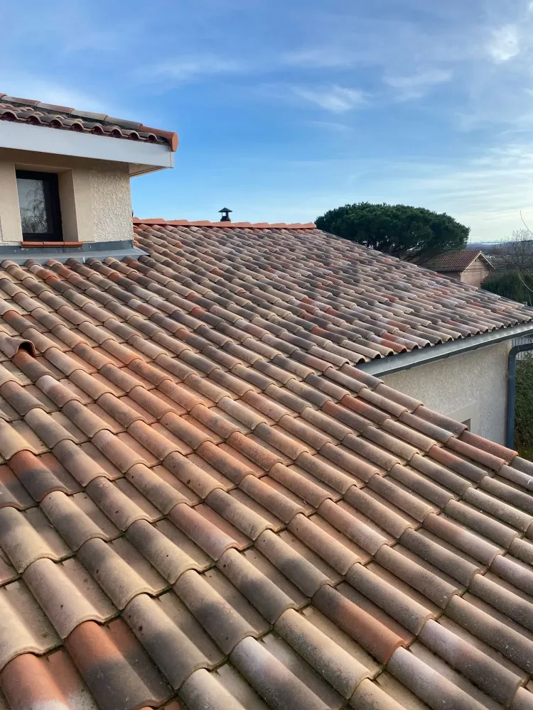 Toit en tuiles rouges sous un ciel bleu clair